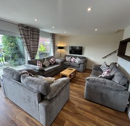 A living room with sofas and a television at Willow, Retallack near St Columb Major