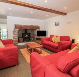 A living room with sofas and a fireplace at Dale Barton in Wells
