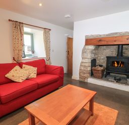 A living room with a sofa and fireplace at Dale Barton in Wells