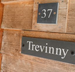 A wooden door with number 37 and a nameplate reading Trevinny at Trevinny Lodge No 37 Davidstow near Boscastle