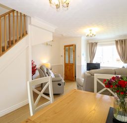 A living room with a sofa and a table at Breydon Cottage in Bradwell near Gorleston-On-Sea