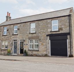 A house with windows and a garage at Hasting Dairy in North Sunderland near Seahouses