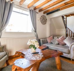 A living room with a coffee table and sofa at Woodland Cottage in Garth