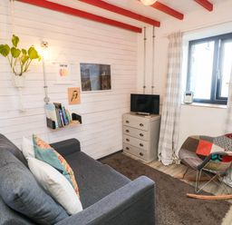 A living room with a sofa and television at Grain Store near Narberth
