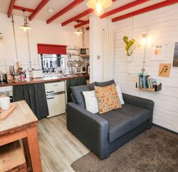 A kitchen with a sofa and wooden counter at Grain Store near Narberth