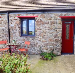 An outdoor area with a table and chairs at Cattle Shed near Narberth