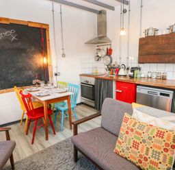A kitchen with colorful chairs and wooden countertop at Cattle Shed near Narberth