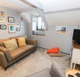 A living room with a sofa and TV at Hayloft near Narberth
