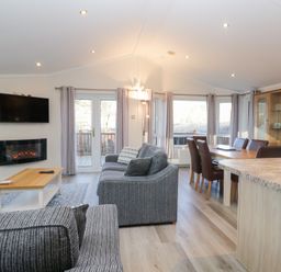 A living room with a sofa and dining area at Heights View in