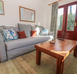 A living room with a sofa and coffee table at Kernyk in Penzance