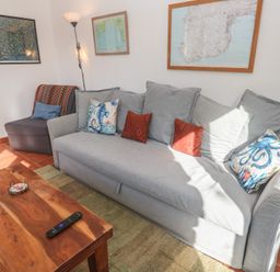 A living room with a sofa and armchair at Kernyk in Penzance
