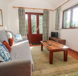 A living room with a sofa and coffee table at Kernyk in Penzance