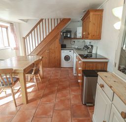 A kitchen with a table and chairs at Kernyk in Penzance