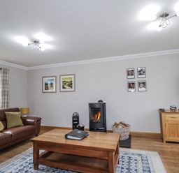 A living room with a sofa and coffee table at Burnside House in Aviemore