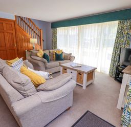 A living room with sofas and a coffee table at Waterhead Cottage in Ecclerigg, near Troutbeck Bridge