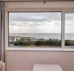 A living room window overlooking the sea at Bryn Deryn in Criccieth