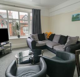 A living room with sofas and a coffee table at Sea Breeze in Rhos-on-Sea