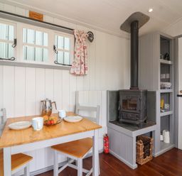 A dining area with a table and chairs at The Shepherds Hut in Chippenham