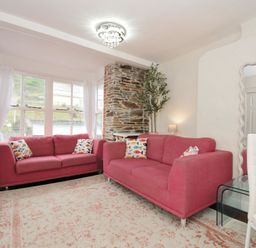 A living room with a sofa and television at Stargazy in Trebarwith Strand near Tintagel