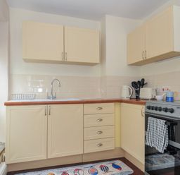 A kitchen with cabinets and appliances at Stargazy Trebarwith Strand near Tintagel