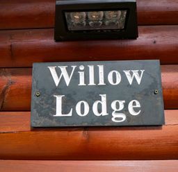 A sign that reads Willow Lodge at Ryedale Country Lodges - Willow Lodge Kirkbymoorside