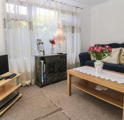 A living room with a sofa and a coffee table at Castell Chalet in Penrhos near Pwllheli
