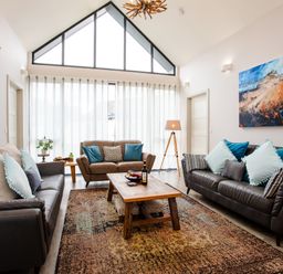 A living room with sofas and a coffee table at Cowslip in Bamburgh