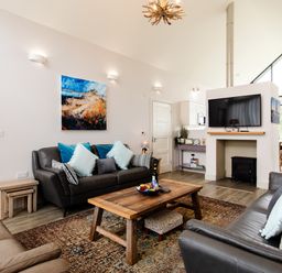 A living room with sofas and a television at Cowslip in Bamburgh
