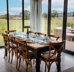 A dining room with a table set for dinner at Cowslip in Bamburgh