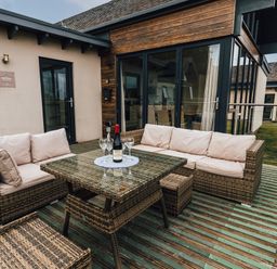 An outdoor seating area with a table and couch at Betony in Bamburgh