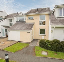 Exterior view of connected houses with tiled roofs grass and pathways at Delfryd in Y Felinheli