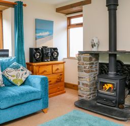 A living room with a sofa and fireplace at The Shippon in Barnstaple