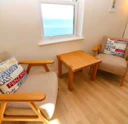 A living room with two armchairs and a coffee table at Meridian in Carbis Bay