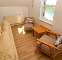 A living room with a sofa and chairs at Meridian in Carbis Bay