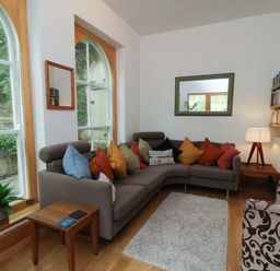 A living room with a sofa and coffee table at Damson Cottage in Whitby