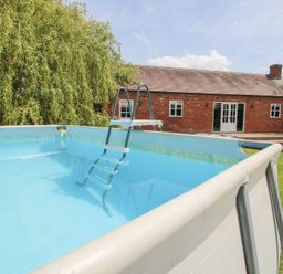 A swimming pool with a ladder at Hilltop House in Tenbury Wells