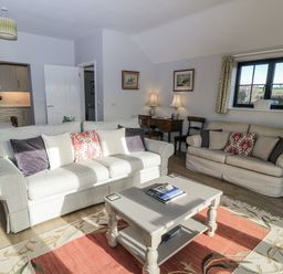 A living room with sofas and a coffee table at Keepers Cottage in West Knoyle