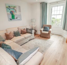 A living room with furniture and decor at Beachcomber in Padstow