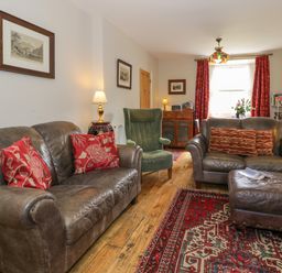 A living room with a sofa and armchair at Sygun View in Beddgelert