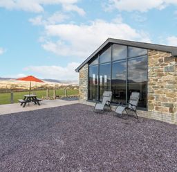An outdoor area with a table and chairs at Cartref in Trawsfynydd