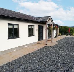 An outdoor view of a house with a pathway at Cartref in Trawsfynydd