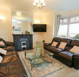A living room with a sofa and coffee table at Preswylfa in Caernarfon
