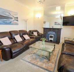 A living room with sofas and a coffee table at Preswylfa in Caernarfon