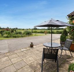 An outdoor area with a table and chairs at Willow Barn in Cucklington near Wincanton