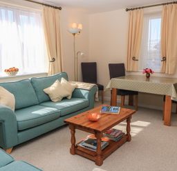 A living room with a sofa and table at Willow Barn in Cucklington near Wincanton