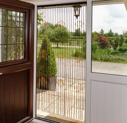 An entrance area with a door and a view of the garden at Little Barn in Cucklington near Wincanton