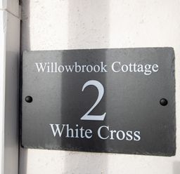 A house number sign reading Willowbrook Cottage 2 White Cross on a wall at Willowbrook Cottage Litton Cheney
