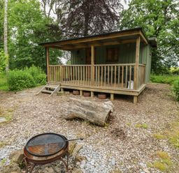 A cabin with a deck in a garden at Bracken Fern in Eppleby