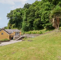 A house with a garden and trees at Old Maids Cottage in Woolacombe