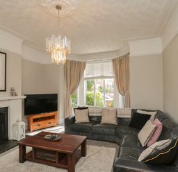 A living room with a sofa and coffee table at Royal Victoria House in Scarborough